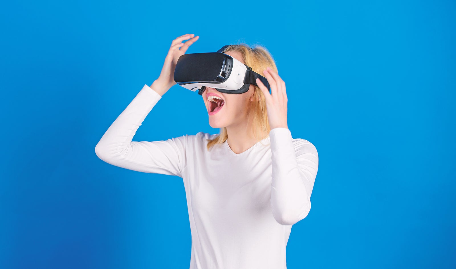 Woman watching virtual reality vision. Woman using virtual reality headset. Funny woman experiencing 3D gadget technology - close up. Digital virtual reality.