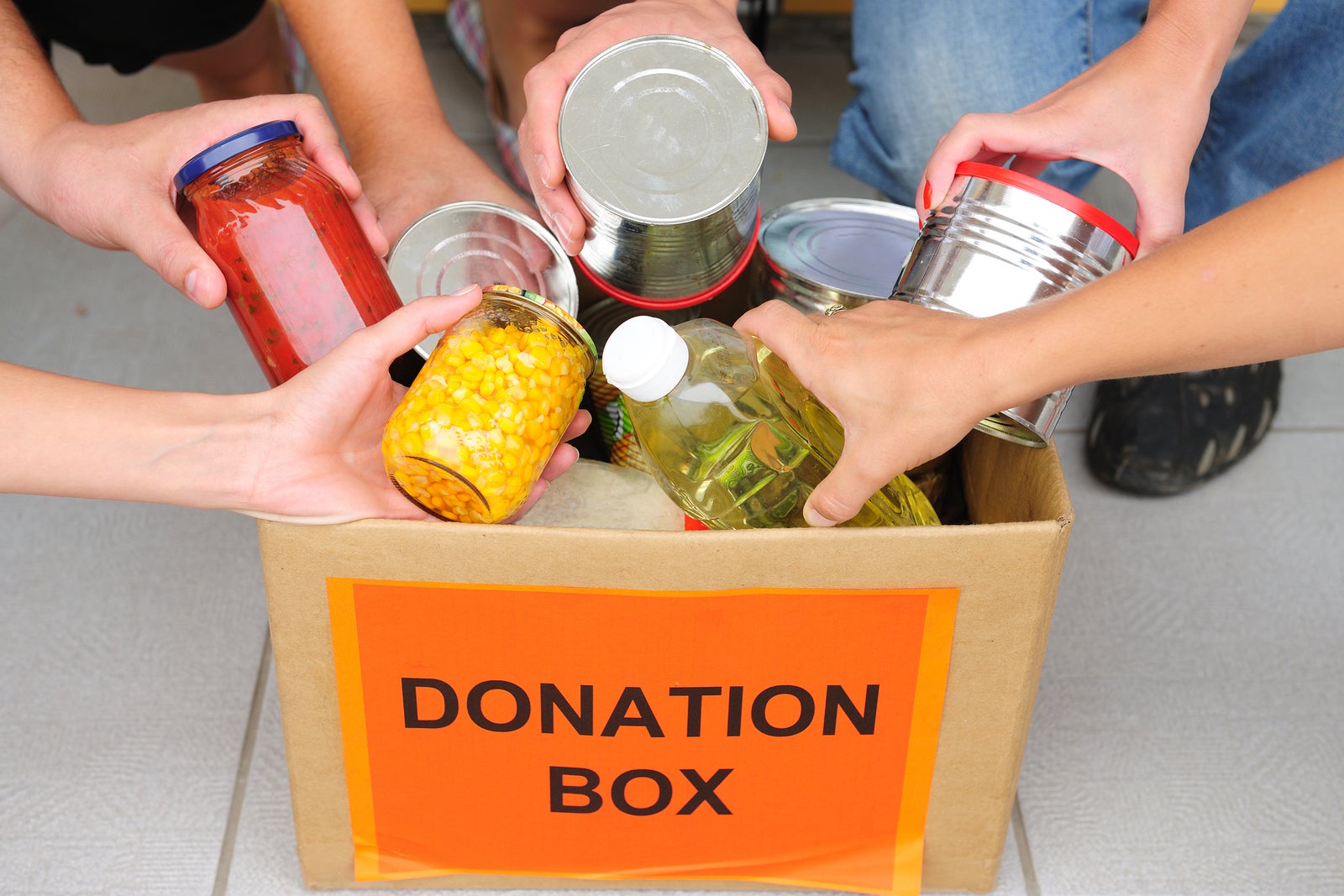 volunteer putting food in a donation box