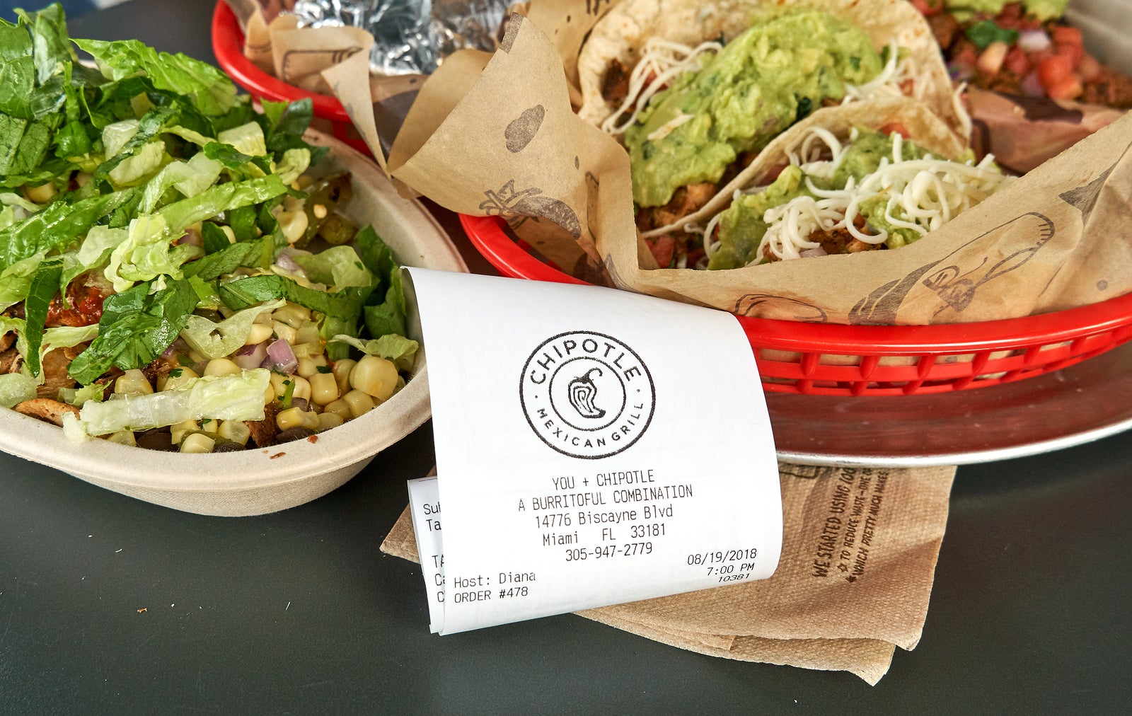 MIAMI, USA - AUGUST 22, 2018: Chipotle plate and receipt. Chipotle restaurant logo. Chipotle Mexican Grill is an American chain of fast casual restaurants
