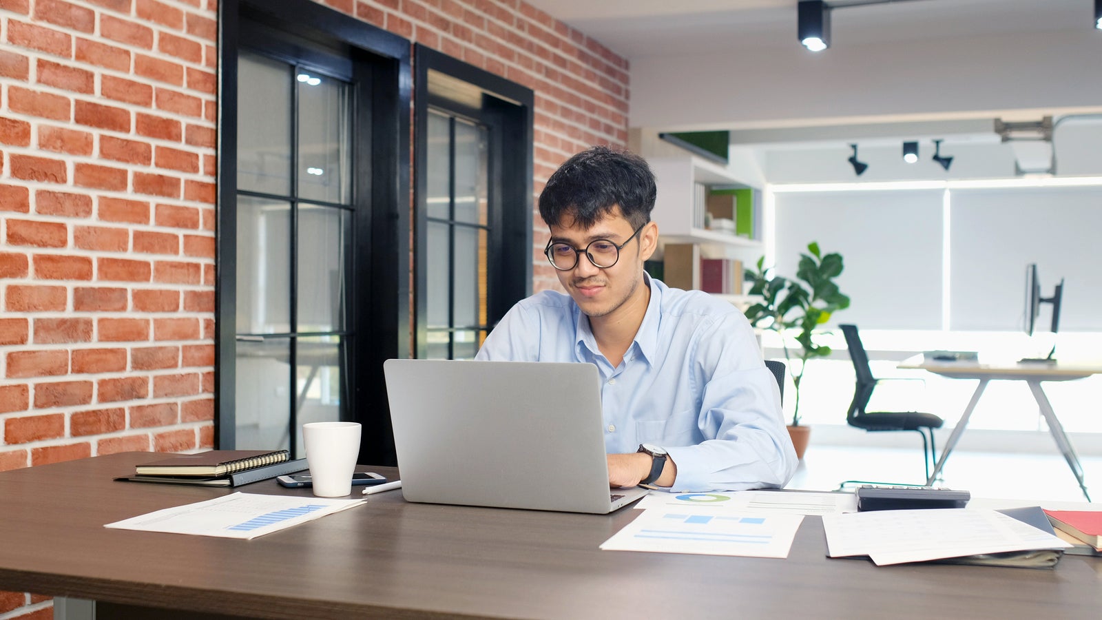 Young asian businessman concentrate on working with laptop computer at office, Asian office man comtemplate on working with laptop computer  business people and office lifestyle concept