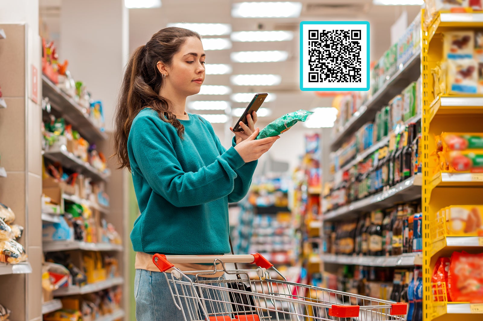 A young beautiful Caucasian woman reads the qr code information using her smartphone. QR-code icon above the product. The concept of purchasing products and mobile apps