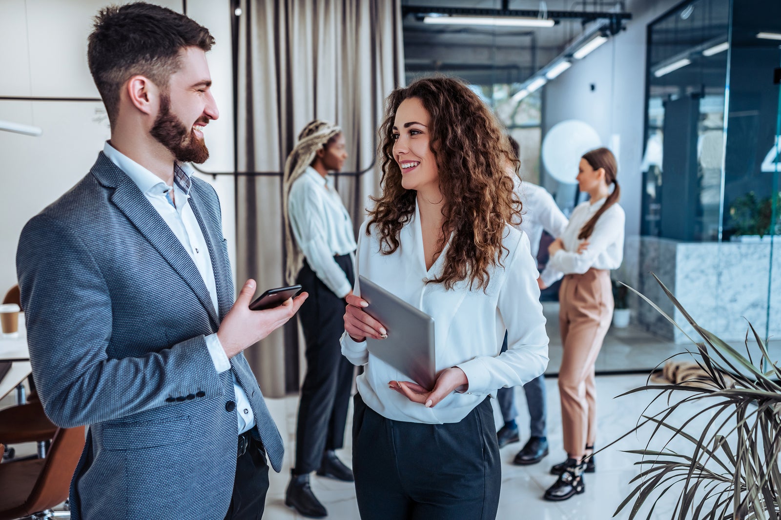 Business professionals. Group of young confident business people talking with each other in the office .Leadership, teamwork and ease atmosphere.