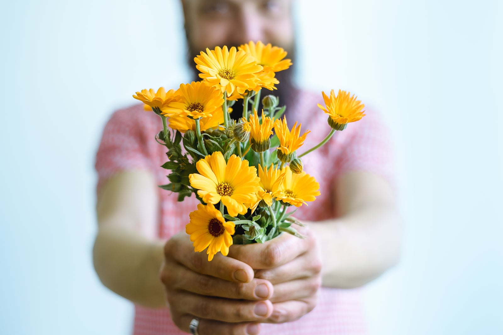 Man holding bouquet of flowers. Man holding yellow flowers. Flowers for postcard and home decoration. Beautiful flowers. Colorful flowers. Flowers home decor. Flower background. flower bouquet close up. Man giving flowers for wedding.