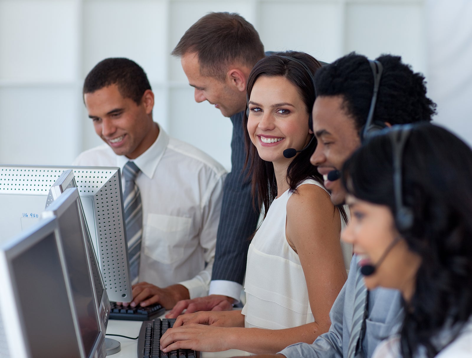 Multi-ethnic business team working in a call center with a manager