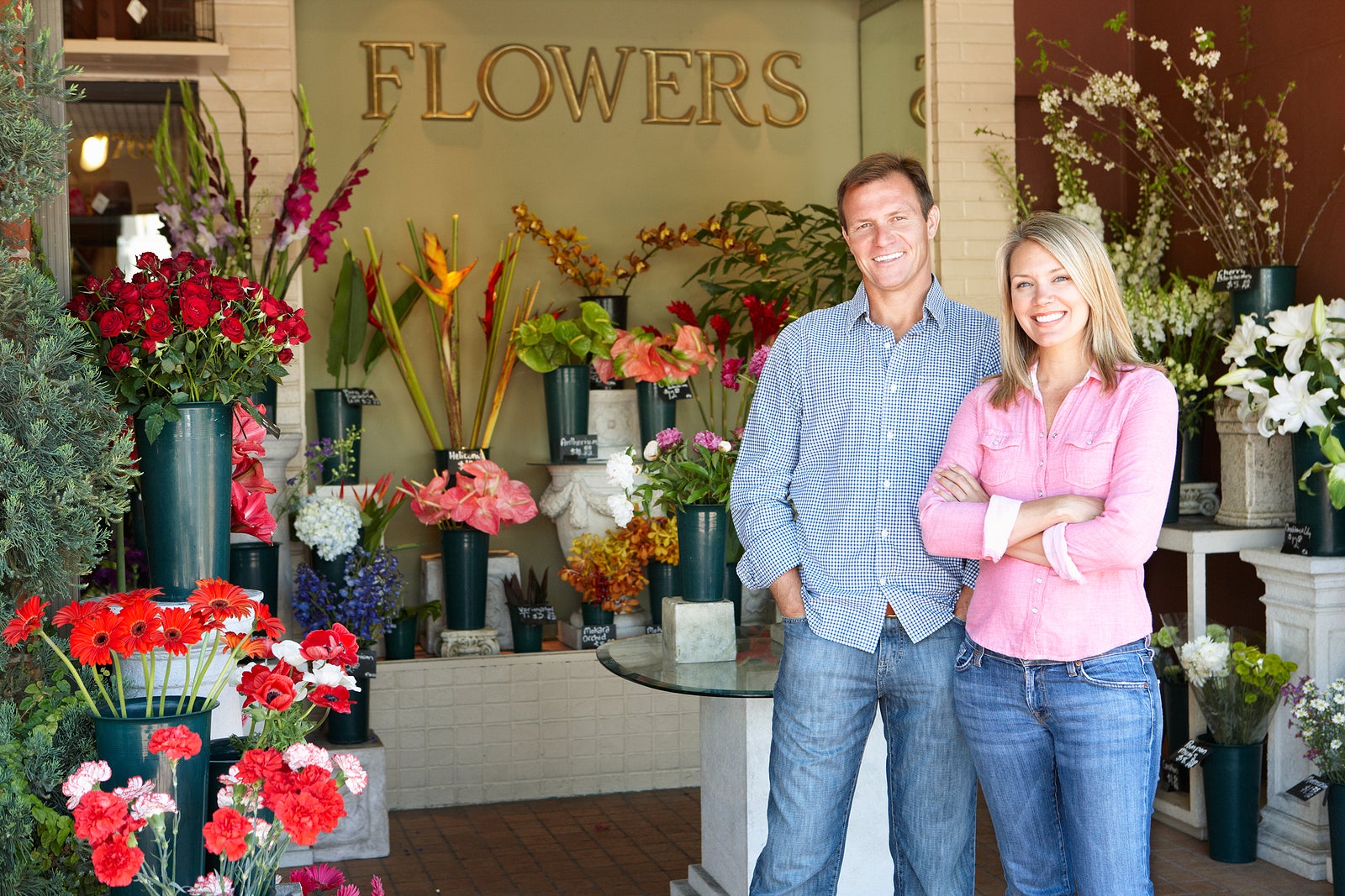 Man and women standing outside florists