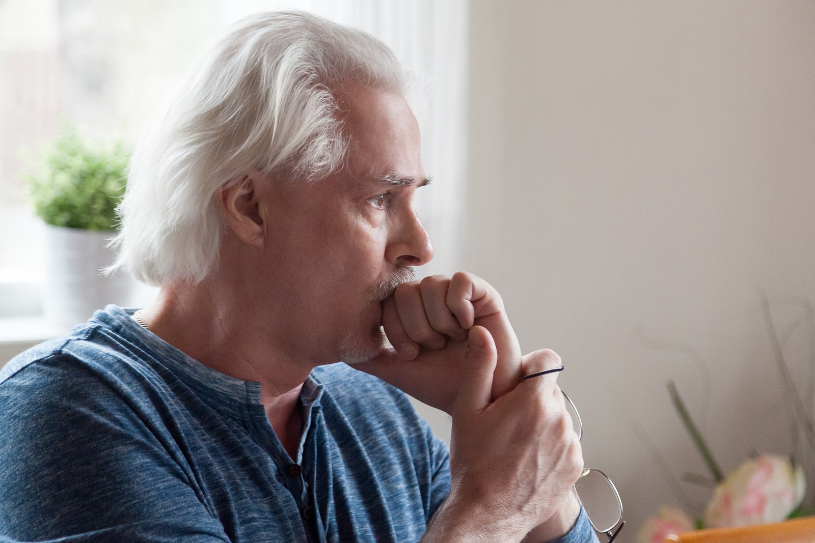 Worried serious senior man looking away feeling anxious about pr