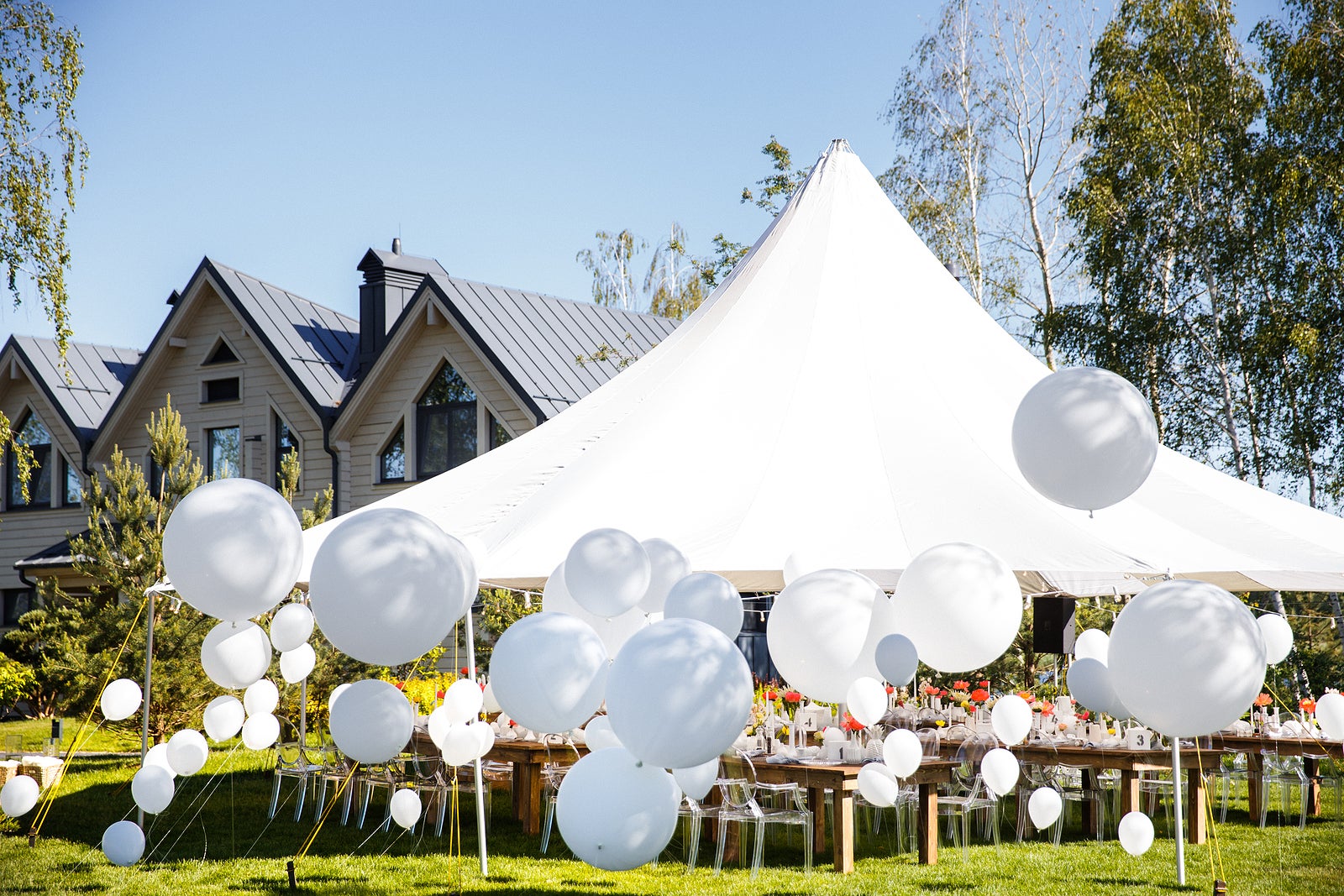 Wedding tent with large balls. Tables sets for wedding or another catered event dinner.