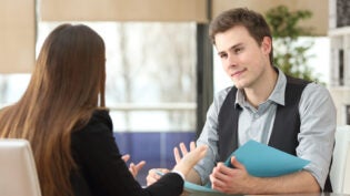 Businessman And Woman Having An Interview Sitting At Office. Wom