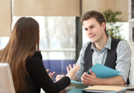 Businessman And Woman Having An Interview Sitting At Office. Wom