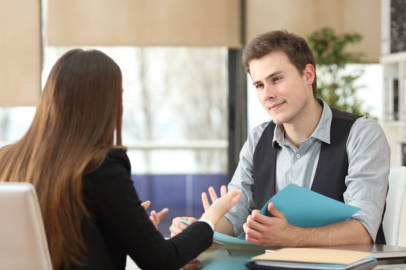 Businessman And Woman Having An Interview Sitting At Office. Wom