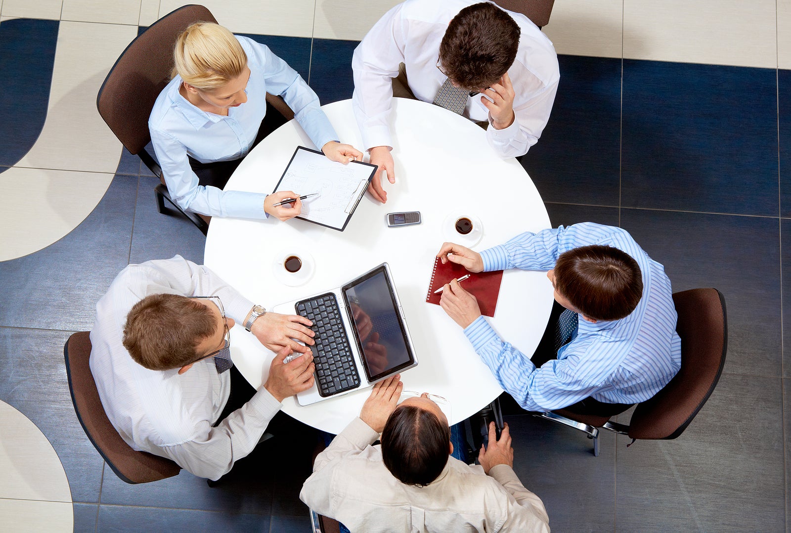 Above view of friendly businessteam working together at meeting