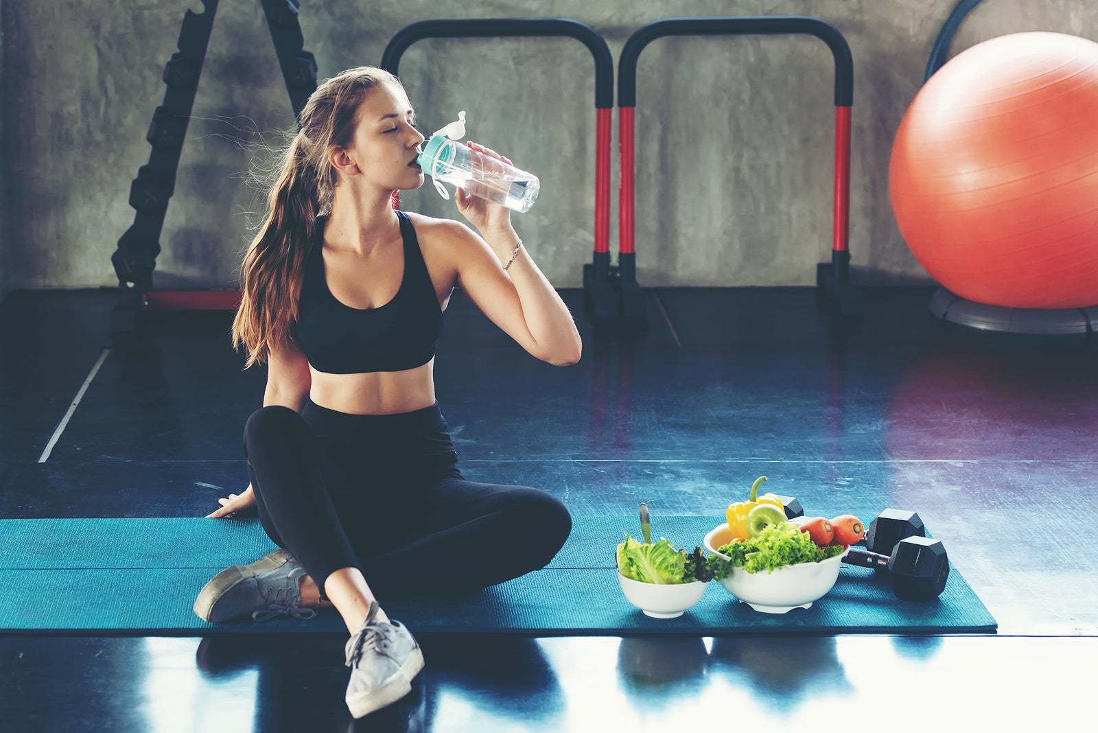 Healthy lifestyle woman drink water at fitness gym. Young people girl workout exercise body for diet and slim health.  Fitness instructor exercising the fitness, copy space and banner for text.  Diet and Health sport Concept