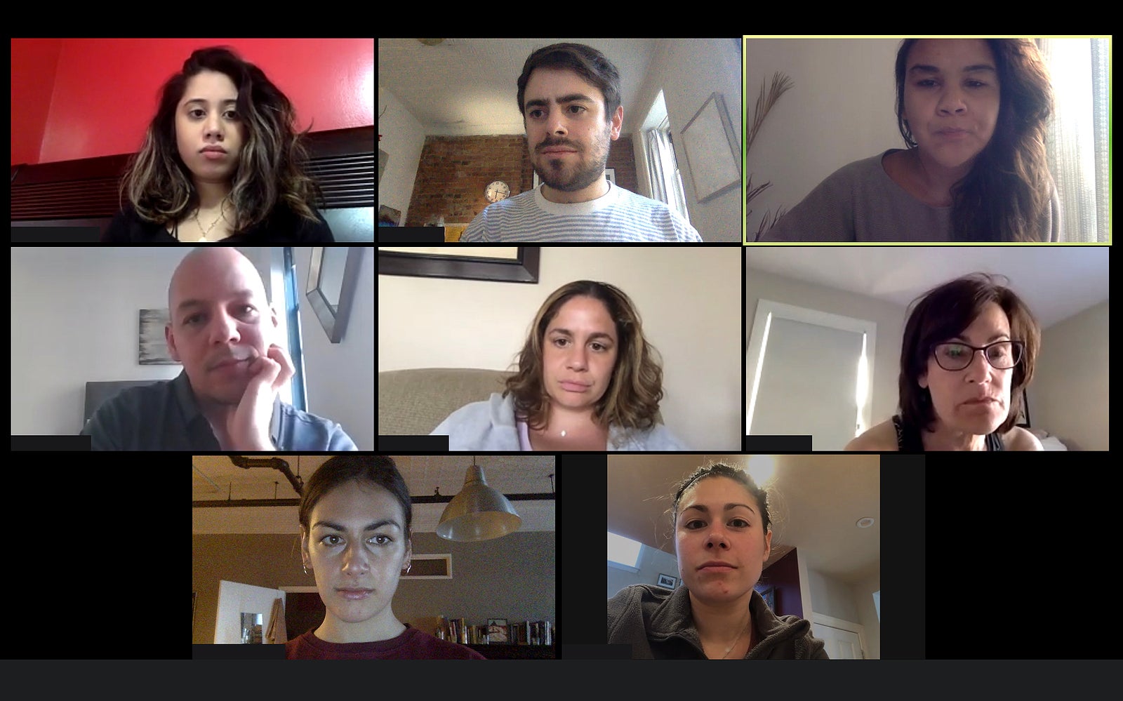 Shot of a screen of teammates doing a virtual conference from their home offices. Team meeting from home.