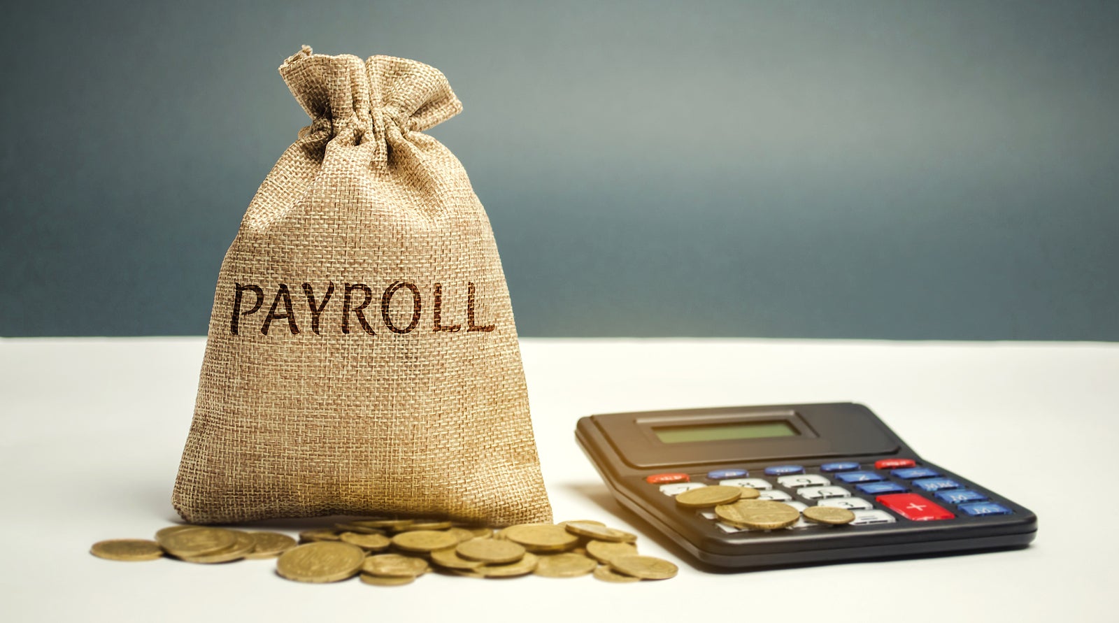 Money bag with the word Payroll and calculator. Payroll is the sum total of all compensation a business must pay to its employees for a set period of time or on a given date. Taxes. Management