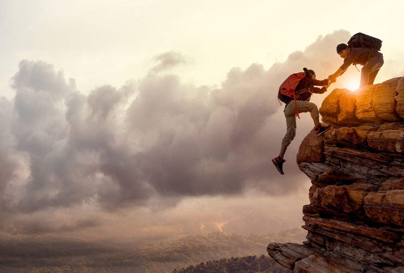 People Helping Each Other Hike Up A Mountain At Sunrise Giving