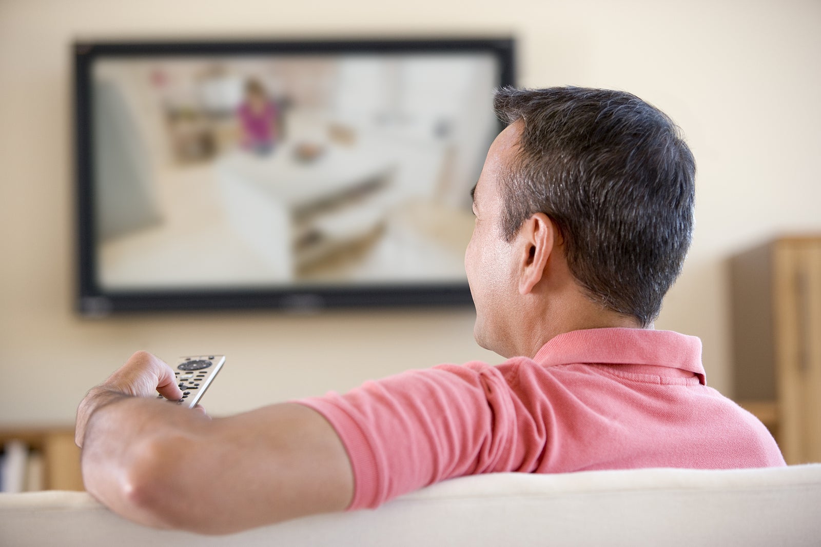 Man relaxing at home watching tv