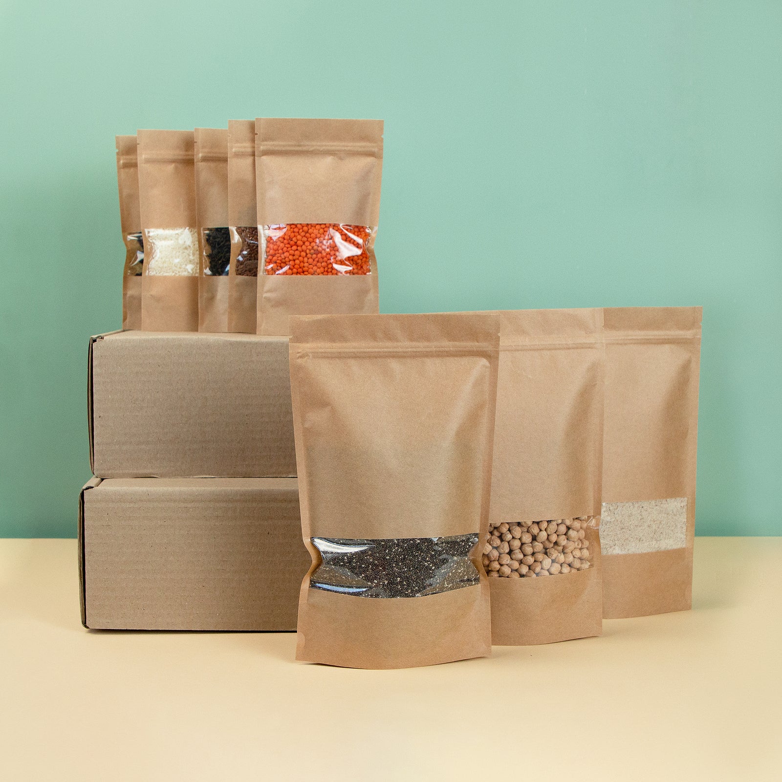 Brown kraft paper doypack bags with groceries front view on a yellow background. Packaging for foods and goods template mock-up. Packs with windows for weight products. Trendy color