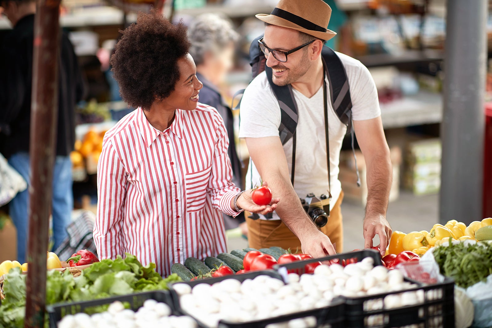 Sales of fresh and organic vegetables and  fruits at the green market or farmers market.  Young couple choose and buy products for healthy food in grocery. All for diet healthy eating, lifestyle.