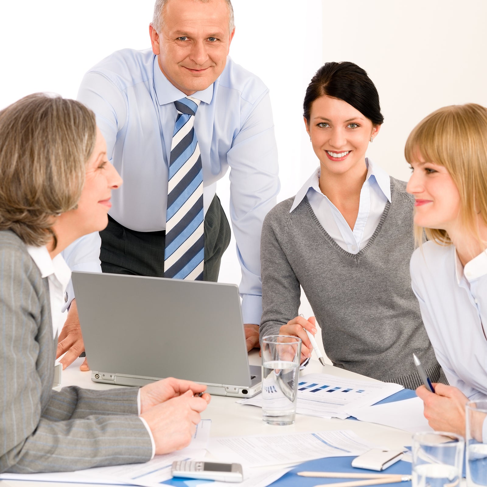 Business team meeting people around table brainstorming in office