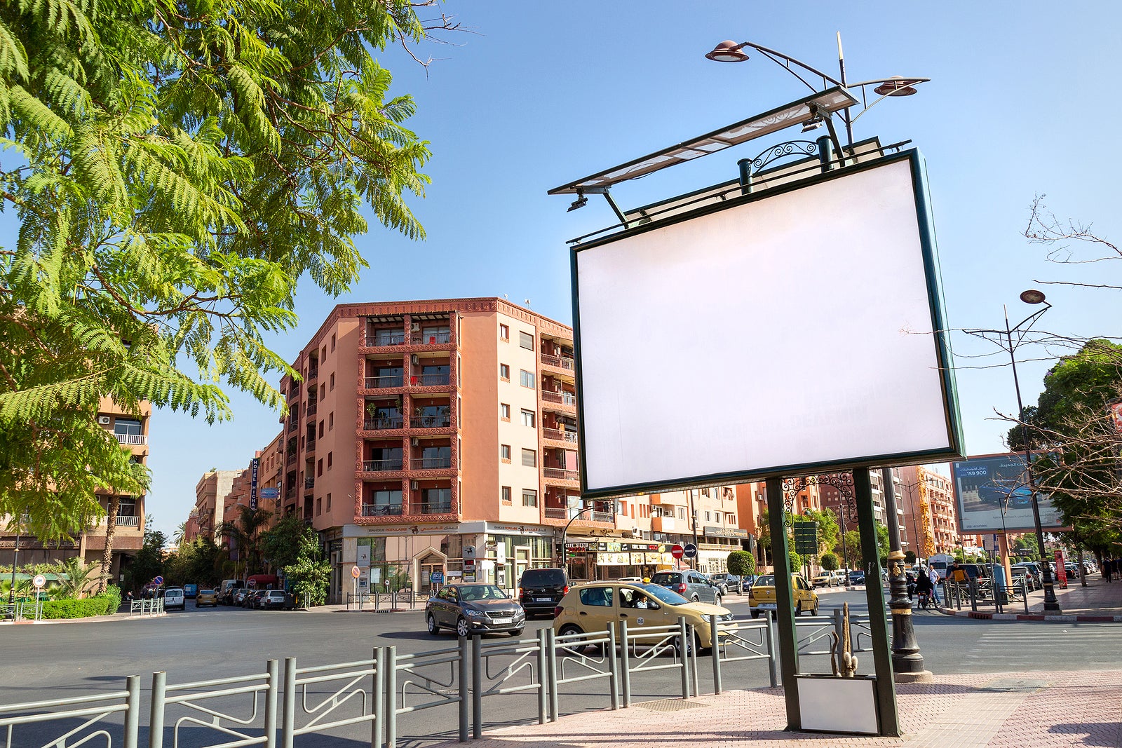Marrakesh, Morocco - 12 October, 2019: Mockup of blank white billboard on urban street. Outdoor billboard or advertising poster with empty copy space