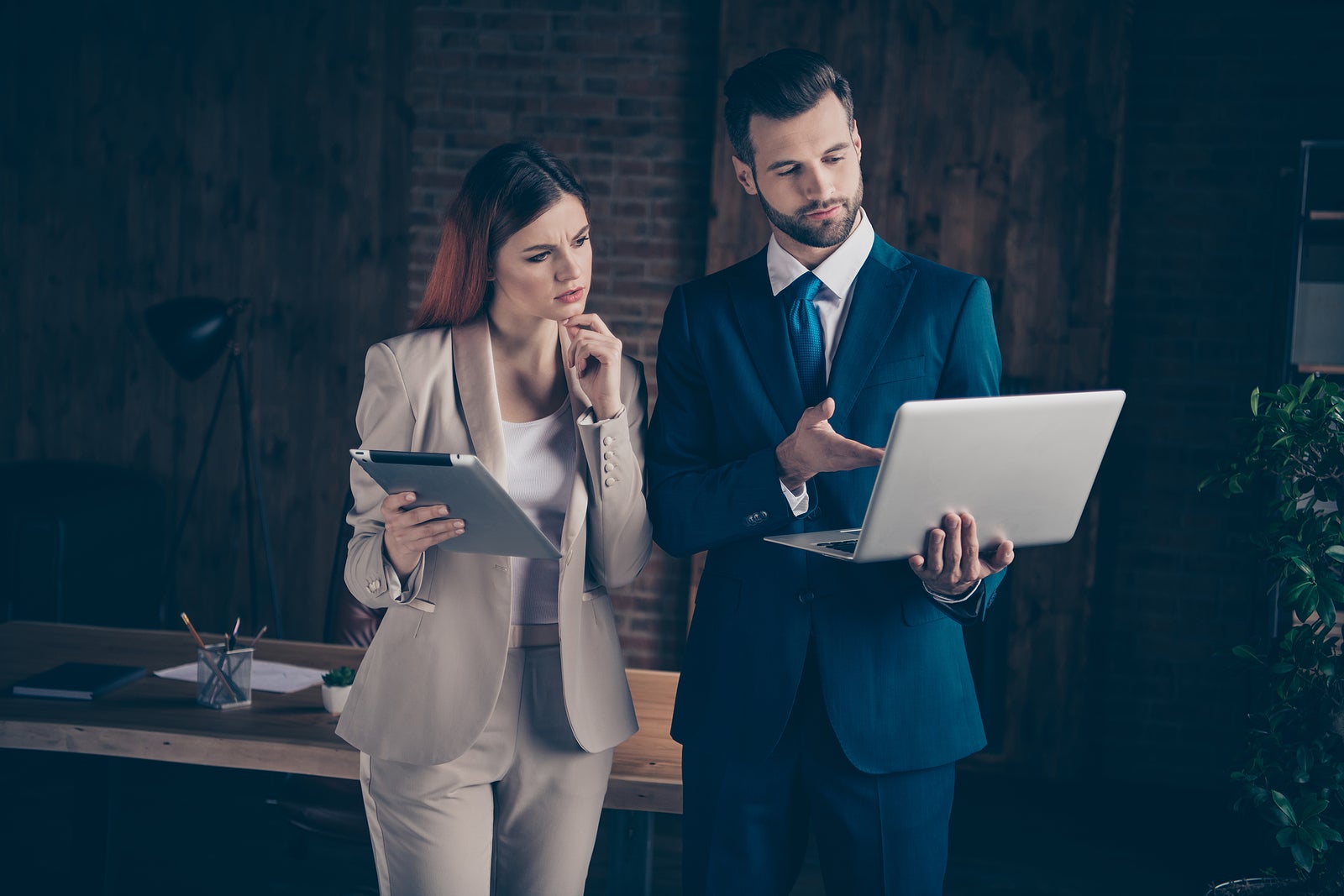 Close up photo attentive she her thoughtful business lady he him his guy boss seo employer banker manager coacher look watch check materials show mistakes office wearing formal wear suit