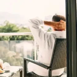 man relaxing on a balcony