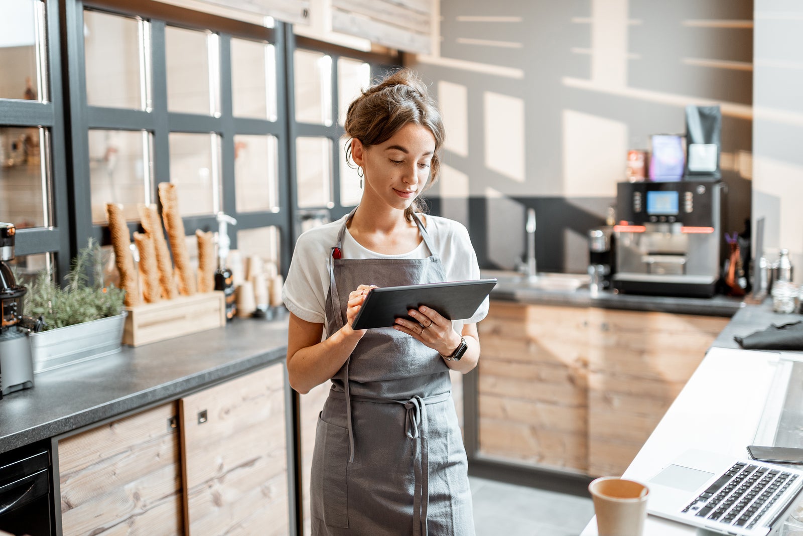 a barista tracking orders on a tablet