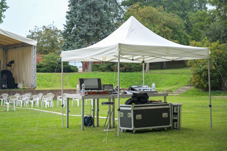 a pop up tent protecting an event's audio equipment