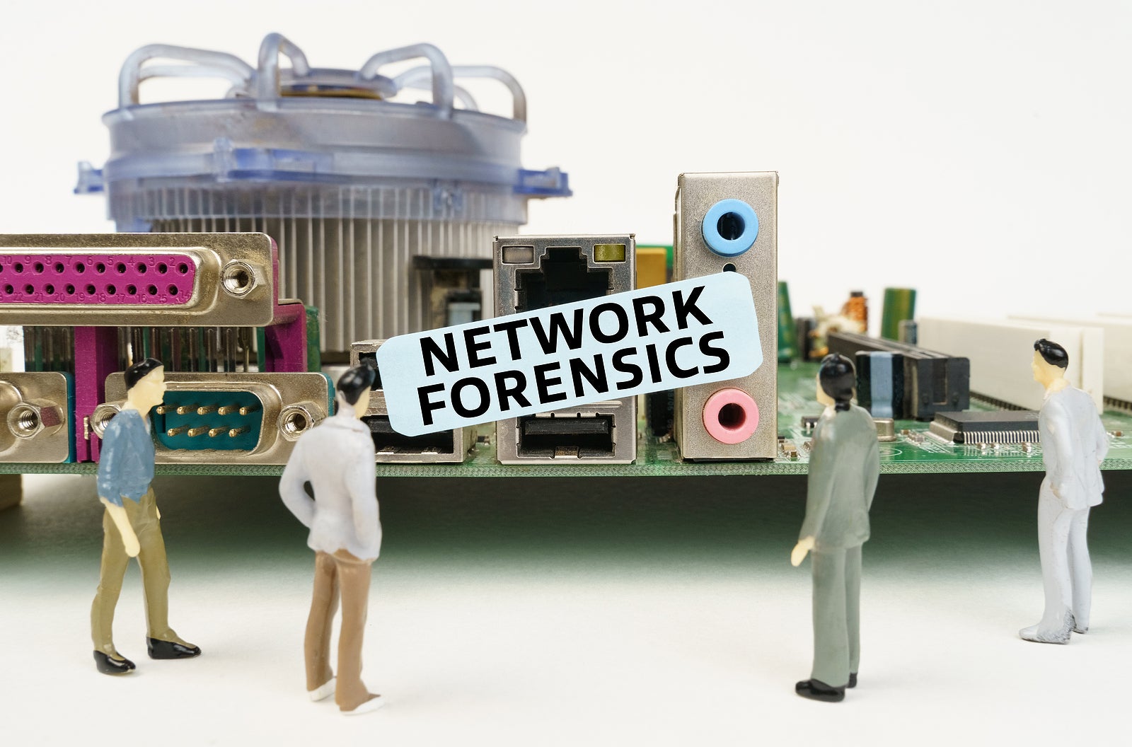 Technology and computer concept. Figures of people are standing near the motherboard and looking at the sticker with the inscription - Network Forensics