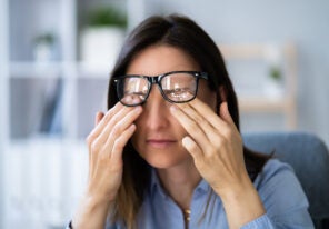 a business woman rubbing her eyes from strain