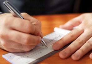 a person writing a check