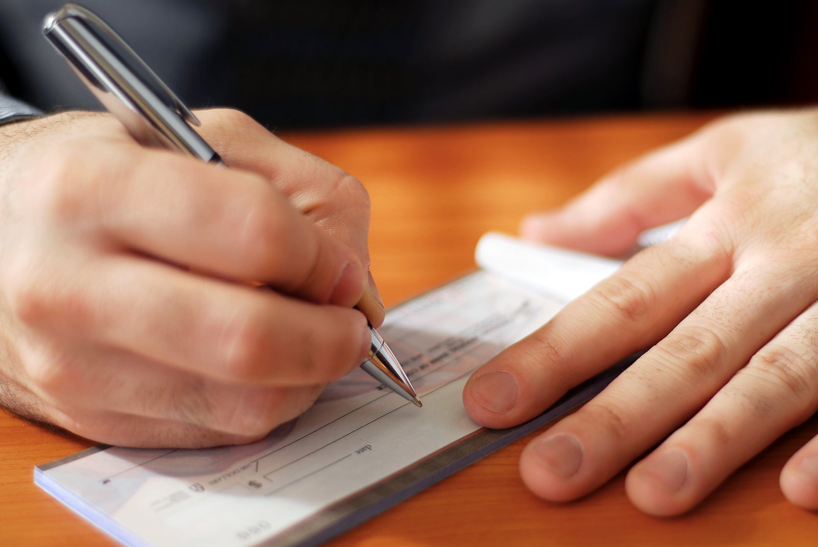 a person writing a check