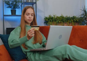 a teenager using a credit card to make an e commerce purchase