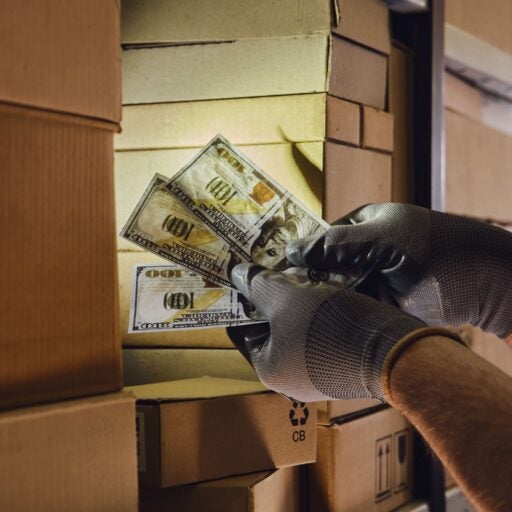 a warehouse employee fanning out money