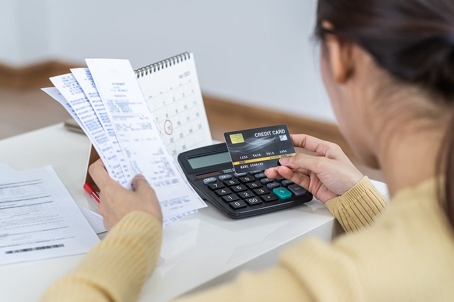 Financial owe asian woman, female sitting on floor home, stressed and confused by calculate expense from invoice or bill, have no money to pay, mortgage or loan. Debt, bankruptcy or bankrupt concept.