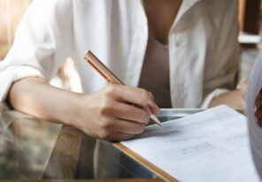 a business person signing a document