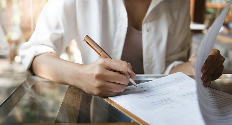 a business person signing a document