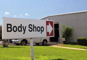 an auto body shop's entrance sign