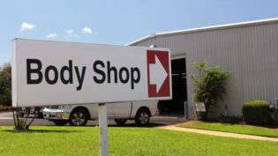 an auto body shop's entrance sign