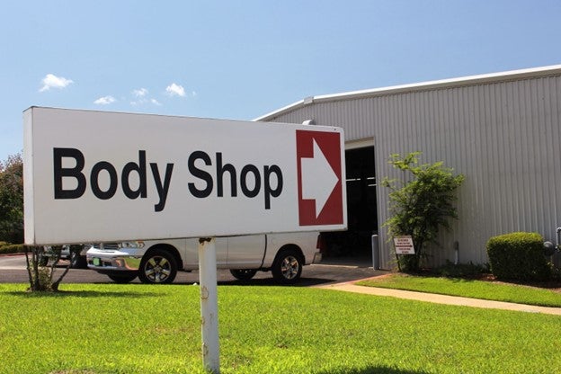 an auto body shop's entrance sign