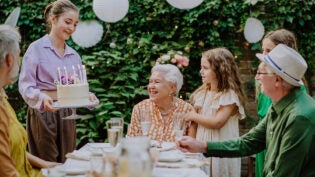 a multi generational family celebrating a birthday