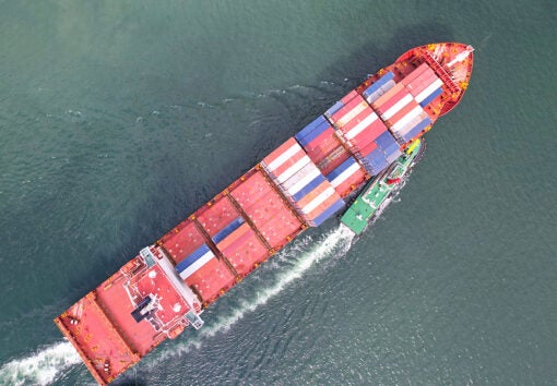 a cargo ship with stacks of containers