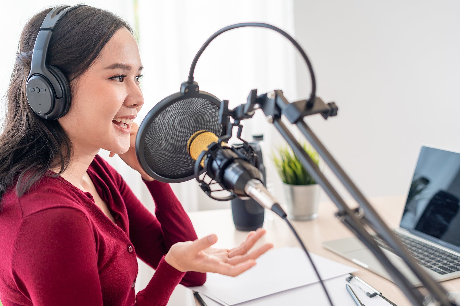 Asian woman is speaking to encourage on a radio broadcasting station. beautiful female organized the radio program. Radio, podcast, live steaming, entertainment, listen, technology, music, speaker