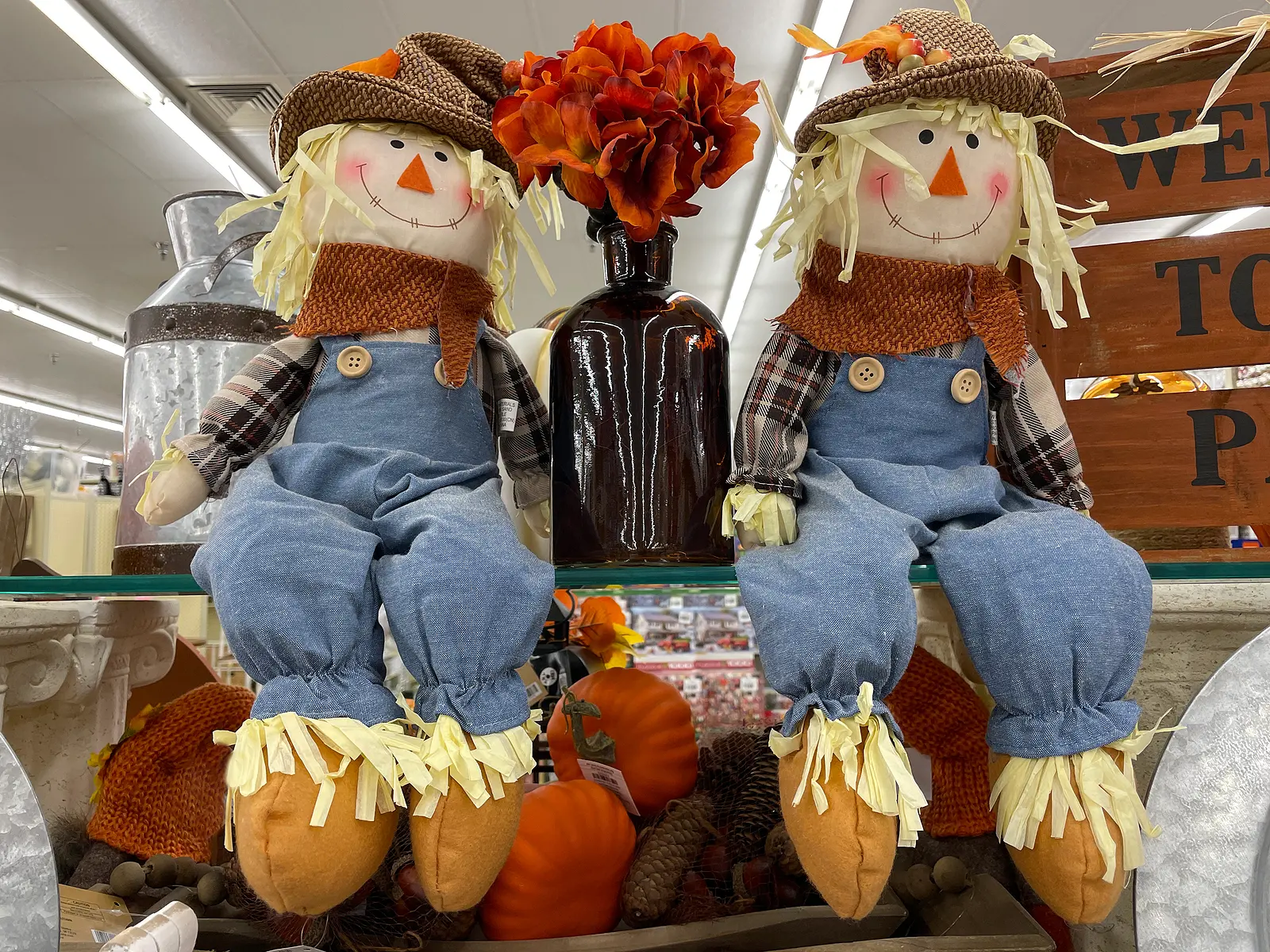 colorful Fall autumn display in a grocery store holiday scarecrows sitting up
