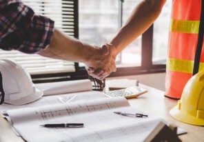 construction workers shaking hands