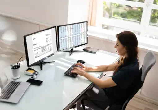 a woman using invoice application software