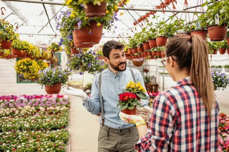 a floral business owner aiding an employee