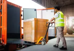 a box safely being loaded into a shipping vehicle