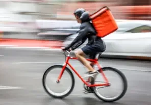 a bicycle delivery person abiding by the law