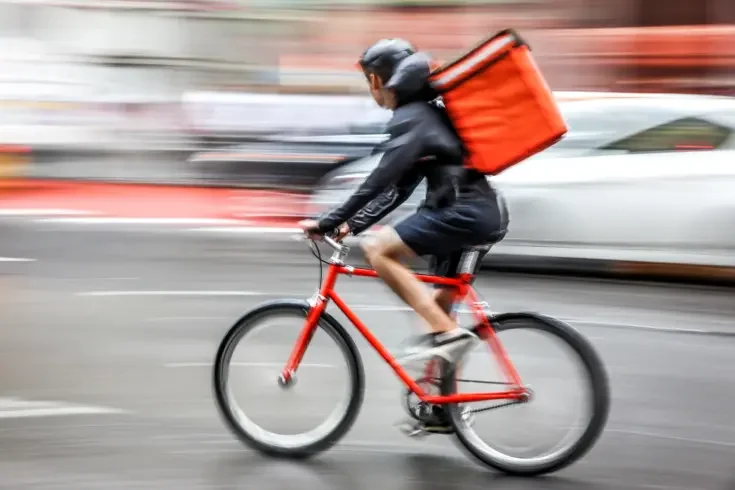 a bicycle delivery person abiding by the law
